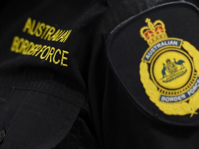 Victorian police, Australian Federal Police and Australian Border Force officers stand in front of approximately 275 kilograms of crystal methamphetamine on display at the Australian Federal Police offices in Melbourne, Monday, July, 4, 2016. A Victoria Joint Organised Crime Task Force (JOCTF) seized the methamphetamine with a street value of $275 million after identifying the syndicate in February, arresting one Malaysian and seven Australians. This is the biggest seizure in Victoria this year. (AAP Image/Tracey Nearmy) NO ARCHIVING