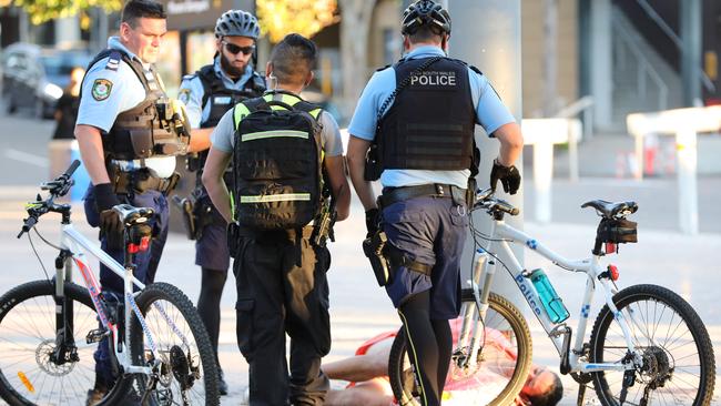 A man falls to the ground in front of police outside the Midnight Mafia music festival. Picture: Damian Shaw