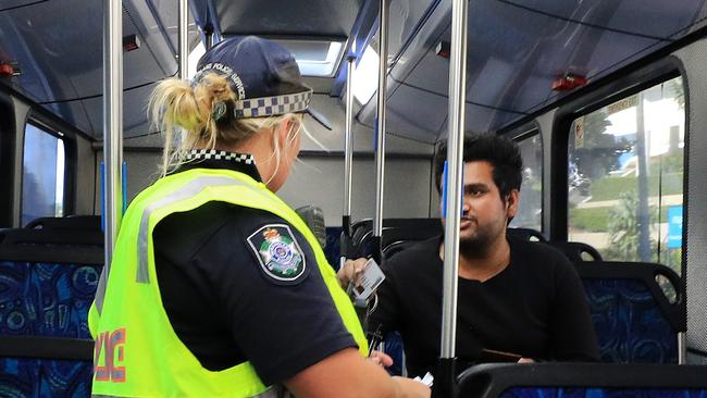 Queensland Police board and question a bus passenger after the announcement of upgraded security checks on all Queensland border travellers. Photo: Scott Powick.