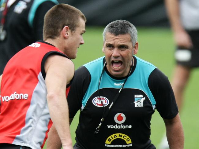 Port Adelaide Power football training at AAMI Stadium - coach Mark Williams yelling, gives footballer Robbie Gray some encouragement to run faster.