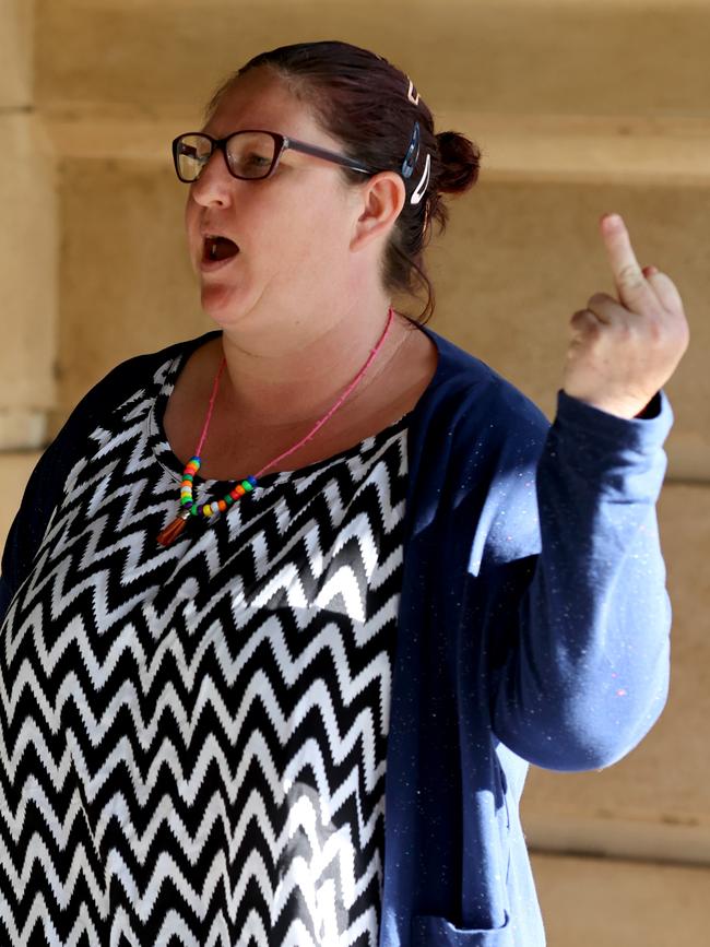 Rhiannon Watherston rudely gestures toward media as she enters the District Court to be sentenced. Picture: NCA NewsWire / Kelly Barnes