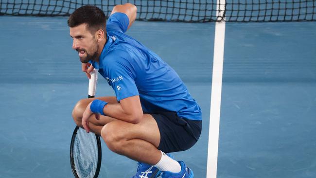 Serbia's Novak Djokovic reacts from an injury while playing against Spain's Carlos Alcaraz during their men's singles quarterfinal match on day ten of the Australian Open tennis tournament in Melbourne on January 21, 2025. (Photo by DAVID GRAY / AFP) / -- IMAGE RESTRICTED TO EDITORIAL USE - STRICTLY NO COMMERCIAL USE --