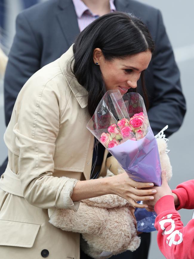 Meghan collects gifts from the crowd. Picture: AAP