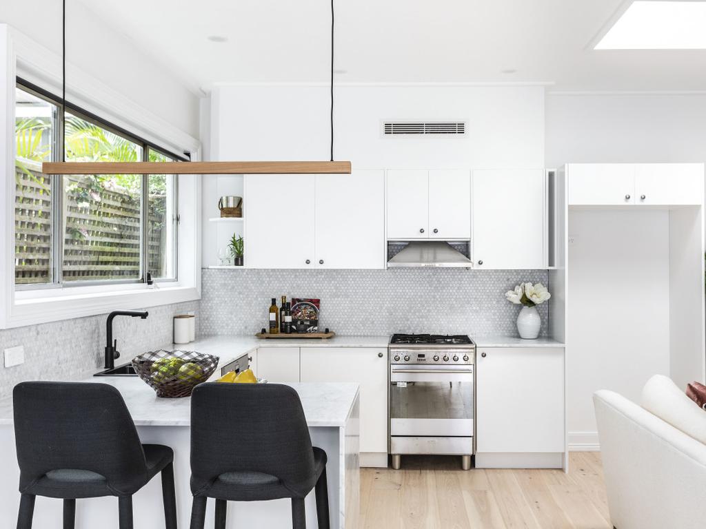 Although the carcass of the kitchen remained the same, an easy coat of white paint freshened up the space. Picture: Supplied.