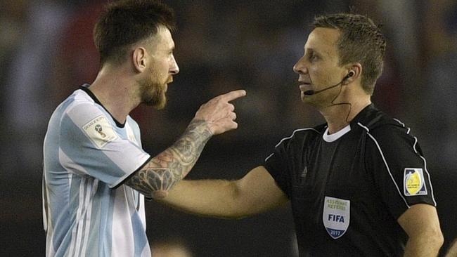 Argentina's forward Lionel Messi (L) argues with first assistant referee Emerson Augusto de Carvalho at full time.