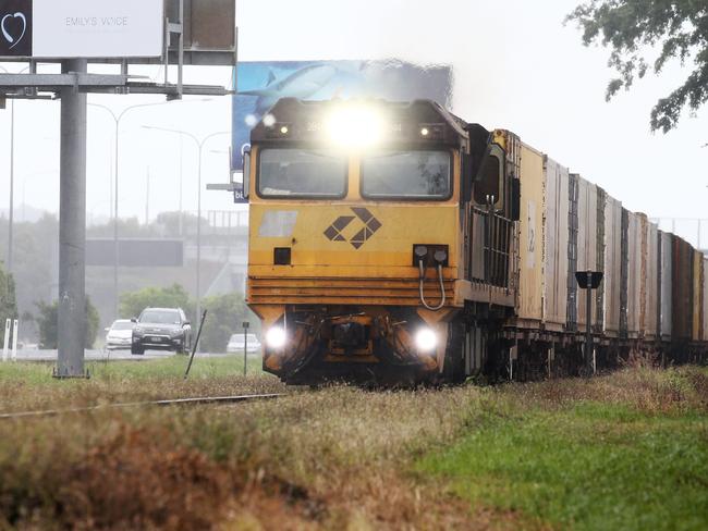 An Aurizon freight train loaded with cargo heads south along the railway tracks at Woree, south of Cairns. PICTURE: BRENDAN RADKE