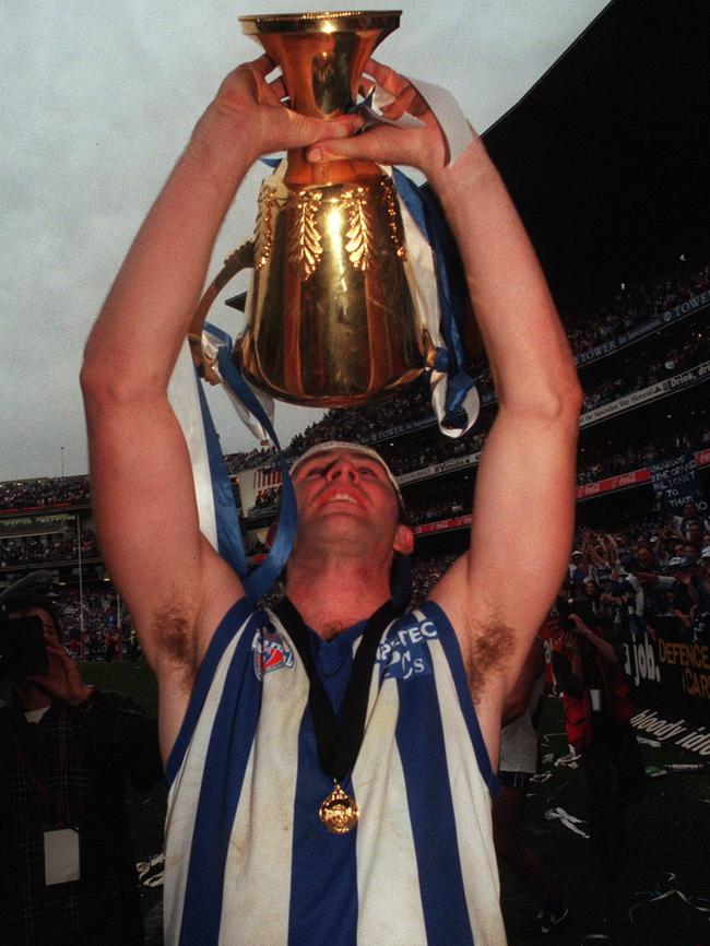 Corey McKernan celebrates with the 1996 premiership cup.