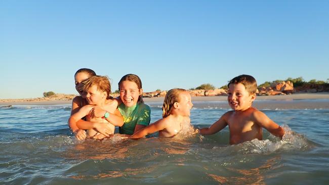 Georgie and Sam Hunt's children Tilly, 12, Lucy, 10, Tom, 7, Clara, 4, and Fred, 3, take a dip during their epic trip.