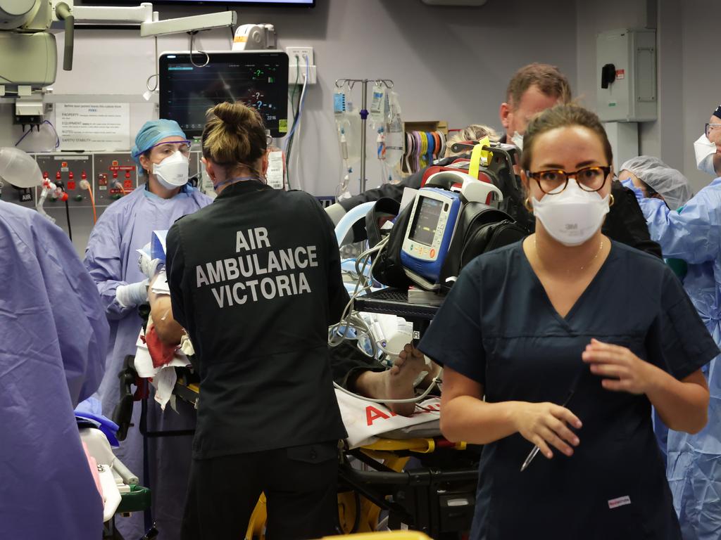 Multiple emergency staff work on a car crash patient. Picture: David Caird