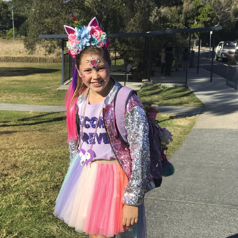 Sophia heading to school when she was nine years old with her glitter ready to sell.