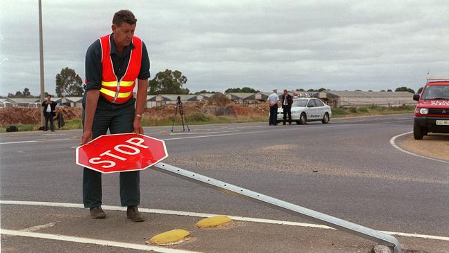 Inspectors clean up after a double fatal crash on Heaslip Road in 1999. Picture: File