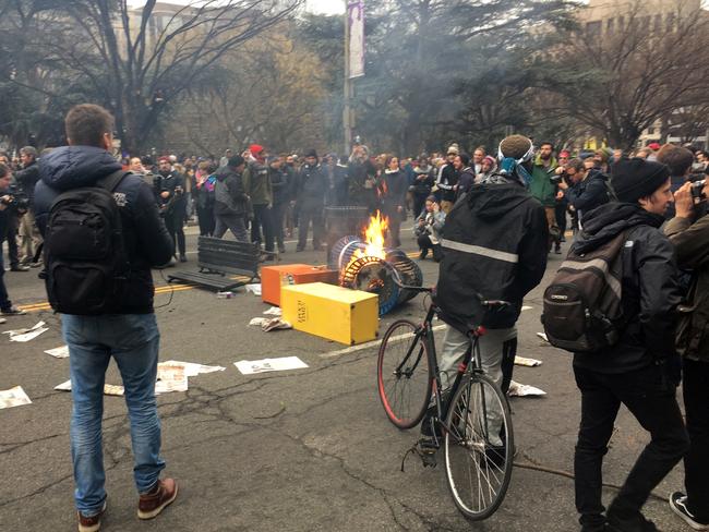Protesters burn rubbish bins and newspaper machine in downtown Washington. Picture: Jack Gillum/AP Photo