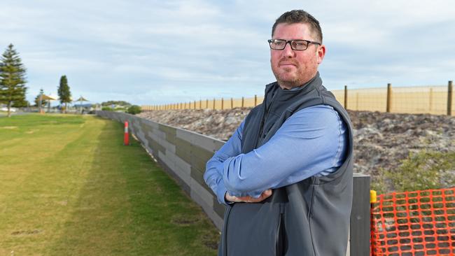 Advanced Plastic Recycling (APR) chief executive Ryan Lokan with a wall built from his company's products at Semaphore. Picture: Tom Huntley