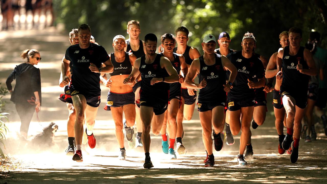 Melbourne players run around the Botanical Gardens on Monday.