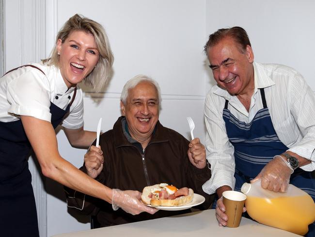 Courtney Roulston and Rocky Massaria serve up a hot breakfast to George. Picture: Craig Wilson