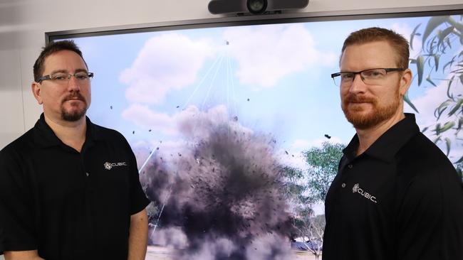 Cubic’s Chris Cali and Christian Connor with a constructive (computer-generated) drone simulation used in a training activity.