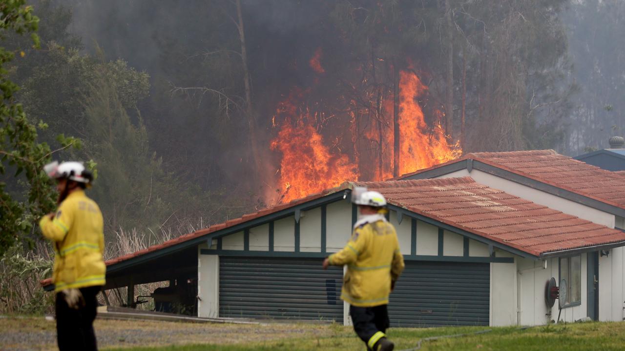 Firefighters battle an out of control bushfire on the Lakes Way, Darawank, near Forster on the NSW mid north coast. Picture Nathan Edwards