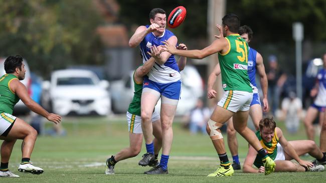 Renton gets a handball away for the ‘Roos. Picture: Field of View Sports Photography