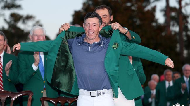 Scottie Scheffler puts the green jacket on Rory McIlroy. Picture:y Richard Heathcote/Getty Images