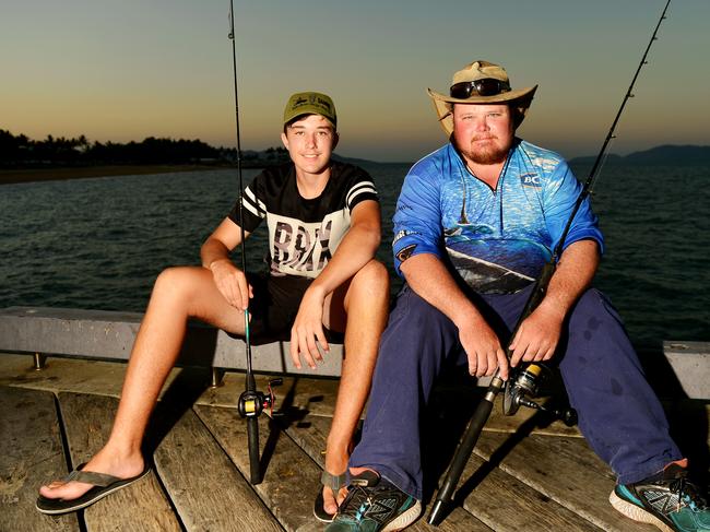 Coree Summerville, 15, and Brad Mikic fishing off the Strand jetty.