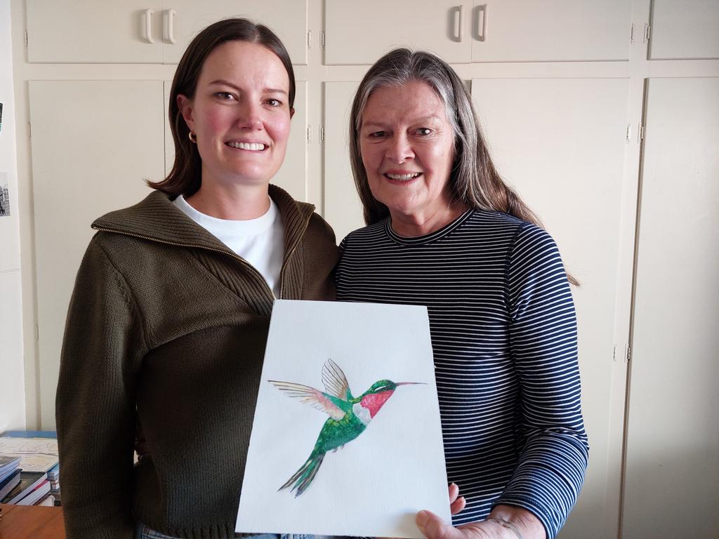 Rosie's mother Vivien Long (L) and grandmother Dean Donnelly (R) with Dean's hummingbird painting which features in the 2024 Hummingbird House appeal. Photo: Contributed