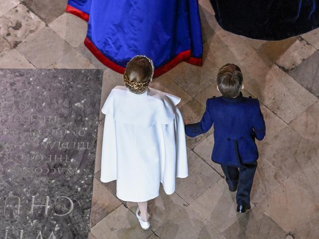 Princess Charlotte, pictured with brother Prince Louis, looked angelic with her white Alexander McQueen cape. Picture: Gareth Cattermole/Getty Images