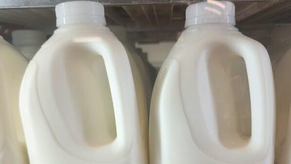Coles has switched out coloured milk caps for clear ones, joining an eco-friendly trend that is emerging in supermarkets across the world. Picture: NewsWire