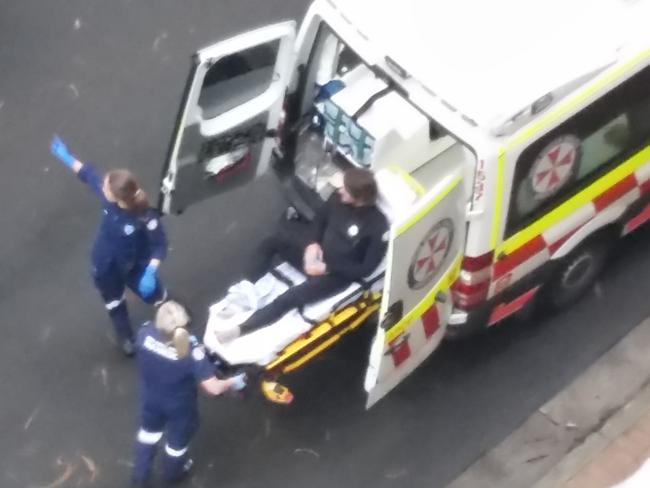 Paramedics load the surfer into the ambulance. Picture: Mark Robinson