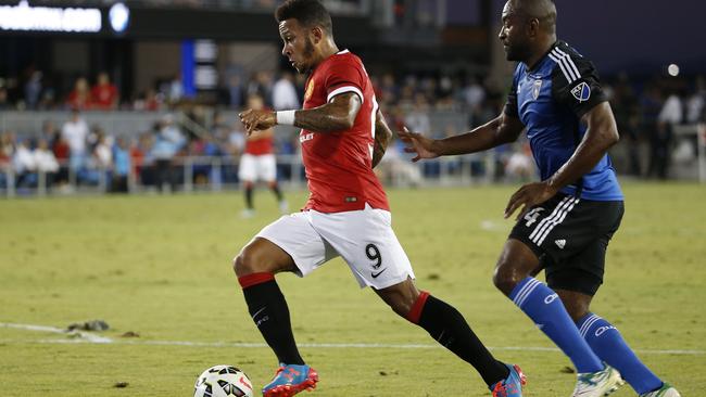 Memphis Depay drives forward to score a goal during the first half.