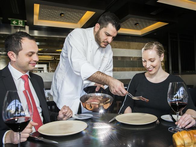 Chef Dany Karam serves Andrea Cortegiani and Vanessa Gregory Sydney's most expensive steak, for $600 per kilogram at Black Restaurant, The Star. Picture: Dylan Robinson