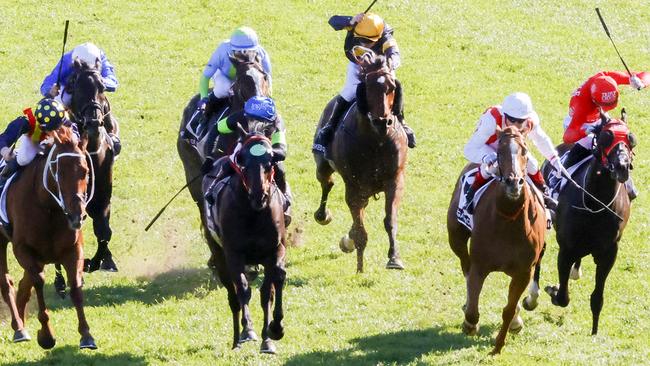 Craig Williams (red and white) on Giga Kick storms home to win the Everest with Mazu (red) rushing late to claim third. Picture: Jenny Evans/Getty Images