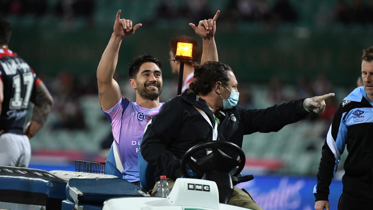 Cronulla’s Shaun Johnson throws out some shakas as he’s taken from the field after suffering a torn Achilles tendon. Picture: Ryan Mckinnon/NRL Photos