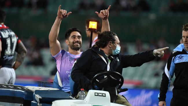 Cronulla’s Shaun Johnson throws out some shakas as he’s taken from the field after suffering a torn Achilles tendon. Picture: Ryan Mckinnon/NRL Photos