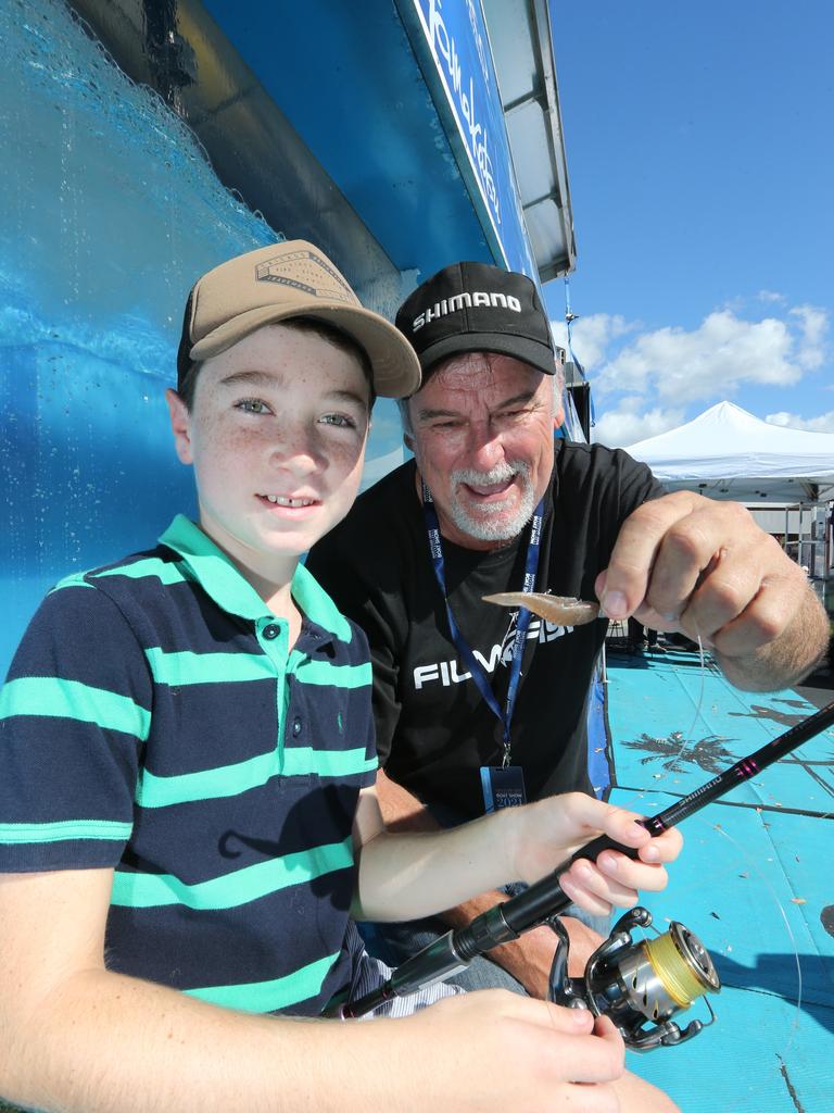 Keiran Nolan, 9, gets some pointers from fishing presenter David Moss from the Shimano Fishing Tank Show at the Sanctuary Cove International Boat Show. Picture: Pic Mike Batterham