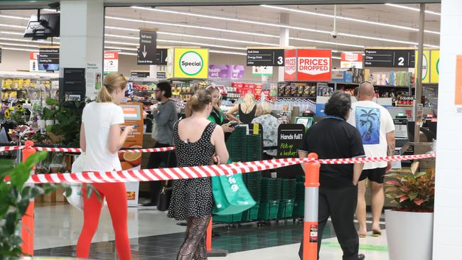 Customers line up to enter Woolworths at Skygate. Picture: Annette Dew.