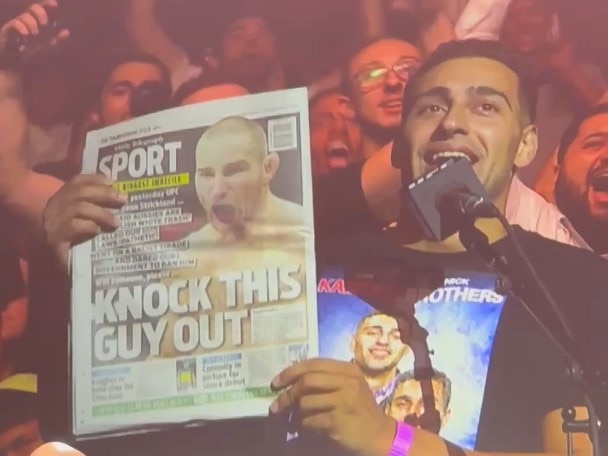 Sean Strickland is shown a copy of the Daily Telegraph’s backpage at a press conference.