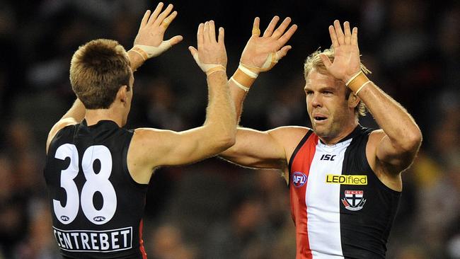 Dunell (left) celebrates a goal with St Kilda teammate Beau Maister. (AAP Image/Joe Castro)