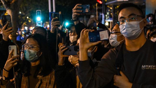 People gather on a street in Shanghai where protests against China’s zero-Covid policy took place the night before. Picture: AFP