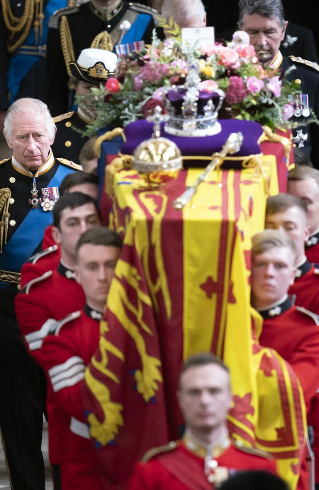 King Charles III follows behind the coffin of Queen Elizabeth II, draped in the Royal Standard with the Imperial State Crown and the Sovereign's orb and sceptre, as it is carried out of Westminster Abbey. Picture: Getty Images