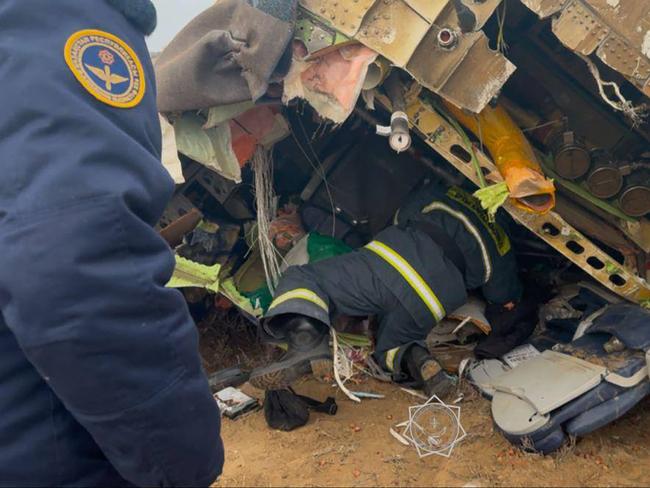 Emergency specialists work at the crash site of an Azerbaijan Airlines passenger jet. Picture: AFP