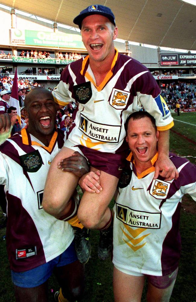 Wendell Sailor (L) and Kevin Walters (R) carrying Allan Langer (C) form the field after the 1998 grand final.