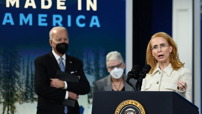 US President Joe Biden and White House National Climate Advisor Gina McCarthy listen as Tritium CEO Jane Hunter speaks during an event about rebuilding manufacturing last year