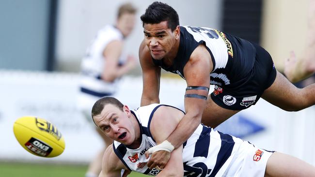 Port Adelaide’s Jake Neade tackles South Adelaide’s Jake Veide. Picture: SARAH REED