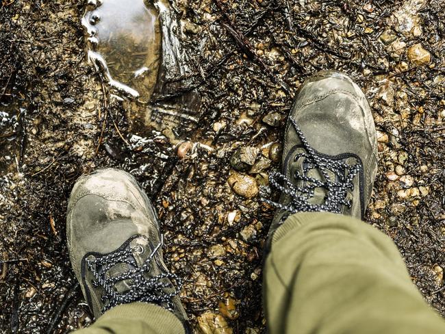 Boots on a muddy trail for City Beat story