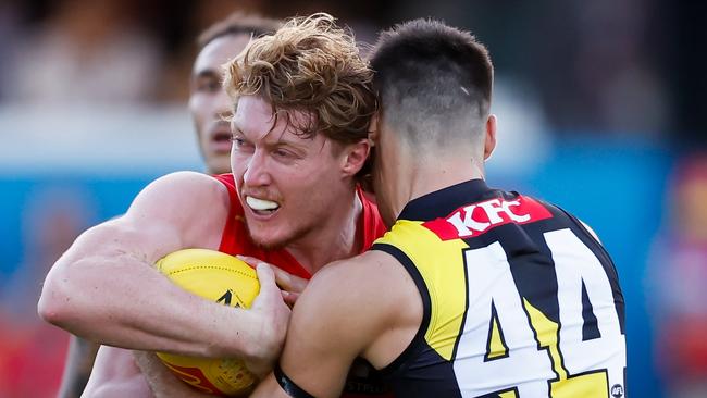 GOLD COAST, AUSTRALIA - MARCH 09: Matt Rowell of the Suns is tackled by Seth Campbell of the Tigers during the 2024 AFL Opening Round match between the Gold Coast SUNS and the Richmond Tigers at People First Stadium on March 09, 2024 in Gold Coast, Australia. (Photo by Dylan Burns/AFL Photos via Getty Images)