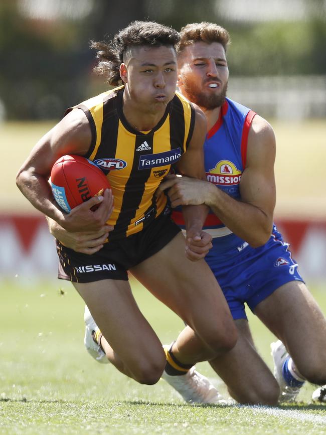 Connor Downie of the Hawks and Marcus Bontempelli of the Bulldogs contest the ball during the AFL Practice Match between the Western Bulldogs and the Hawthorn Hawks at Whitten Oval on February 24, 2021 in Melbourne, Australia. (Photo by Daniel Pockett/AFL Photos/via Getty Images)