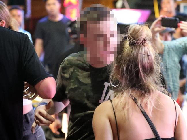 Boy meets girls on the streets of Kuta during the schoolies period in Bali. Photographer: Liam Kidston.