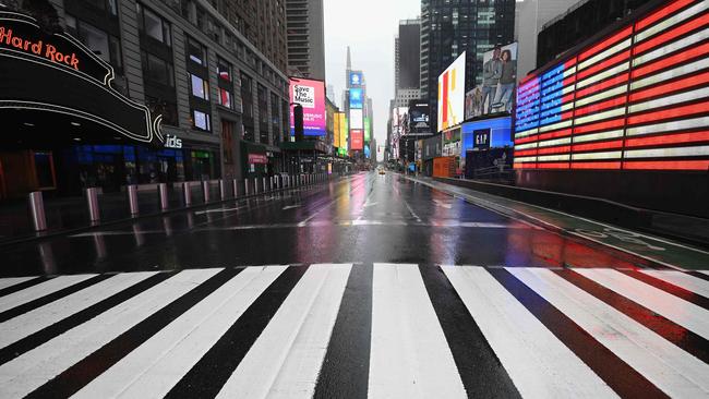 A near-deserted Times Square in New York reflects the global health and economic challenges from the coronavirus. Picture: AFP