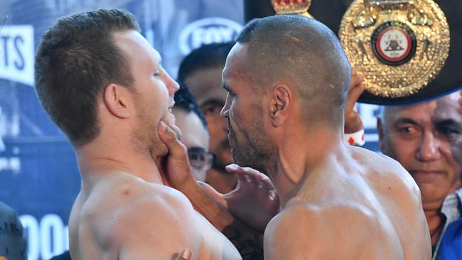 Anthony Mundine grabs Jeff Horn during their weigh-in in Brisbane on Thursday.  Picture: AAP