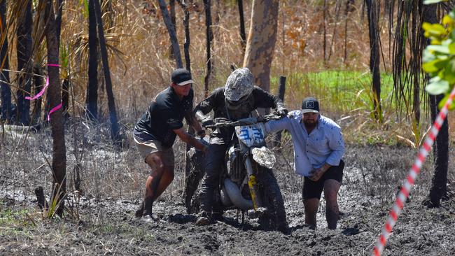 Spectators help haul out a rider from one of the many bogs. Picture: Darcy Jennings